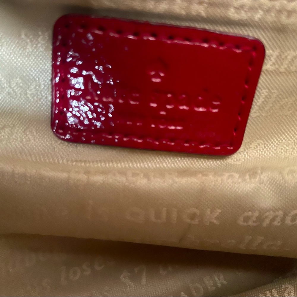 Kate Spade red leather purse, it is in good condition, normal usage.